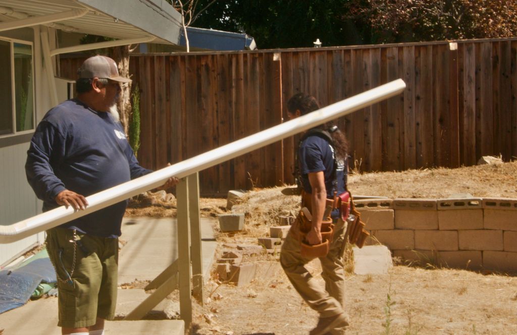 Carrying a seamless gutter run across a backyard job