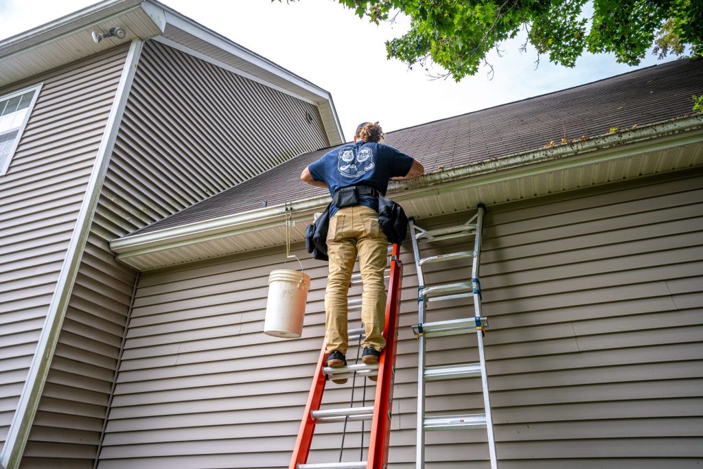 Clearing a gutter run from the ladder