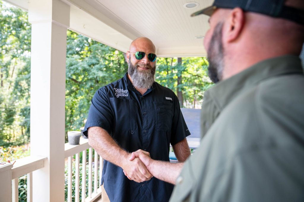 A Solutionist meeting a homeowner on the porch