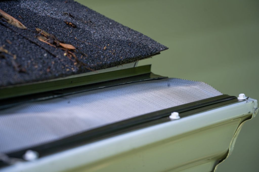 Metal gutter guard fastened under the shingles