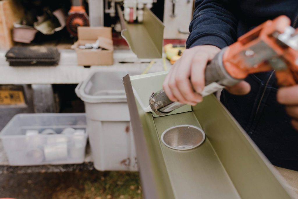 Fitting a downspout outlet into a new gutter section