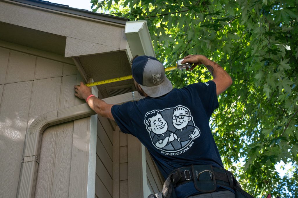 Measuring the fascia before a new gutter run