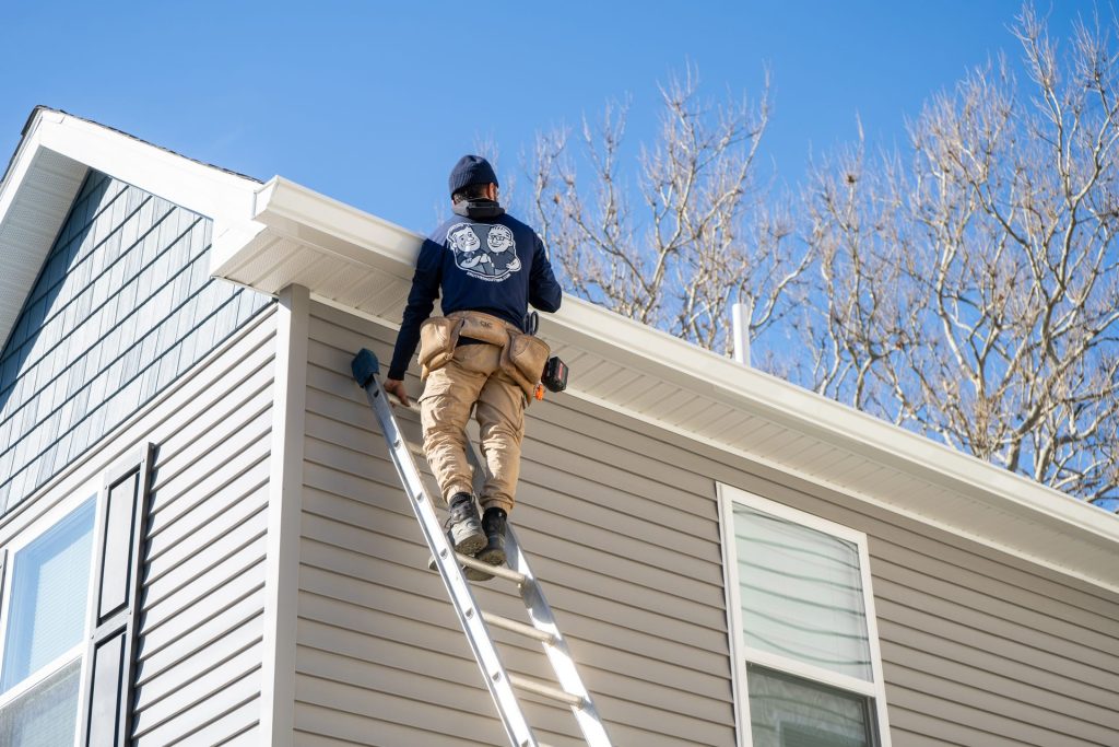 Climbing up to the roofline to inspect the gutters