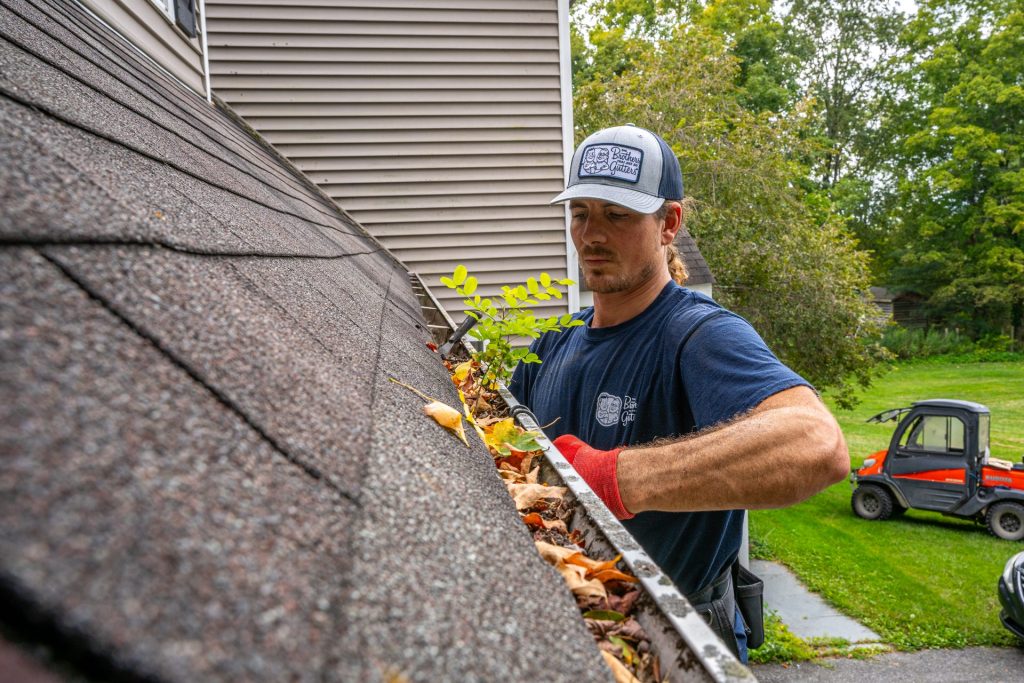 Inspecting a gutter along the roof edge