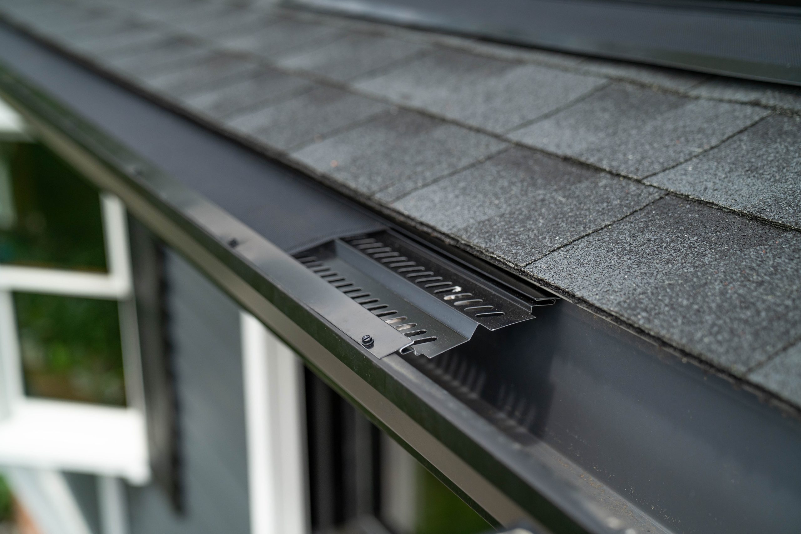 BroGuard micro-mesh fitted along a shingle roof